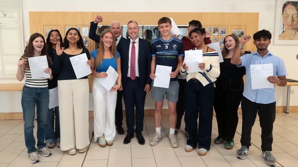 Education Minister Paul Givan (centre) with students receiving their A-level results at Rathmore Grammar School in Finaghy, Belfast