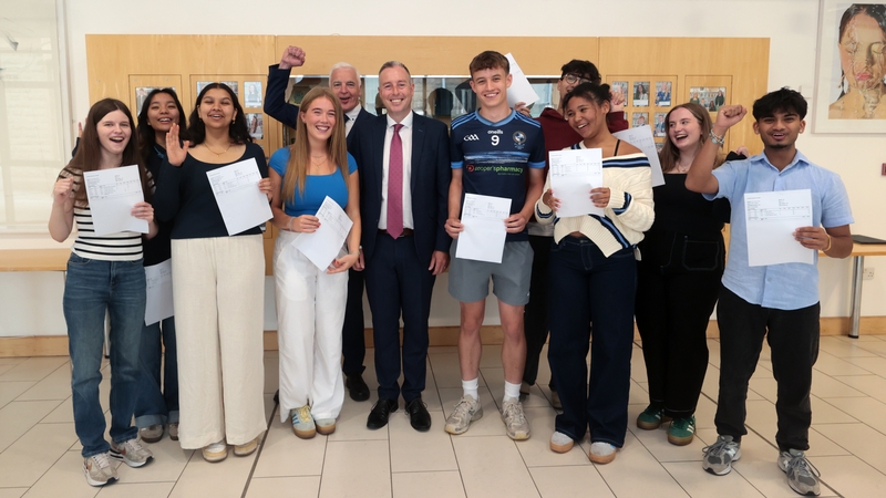 Education Minister Paul Givan (centre) with students receiving their A-level results at Rathmore Grammar School in Belfast this morning
