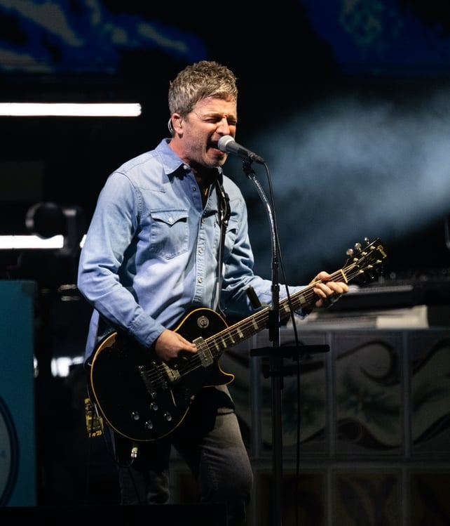 Oasis band member on stage in Cardiff