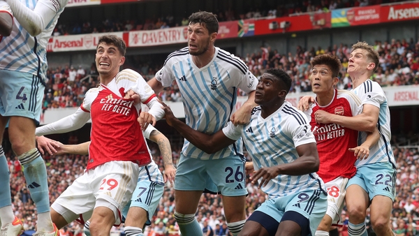 LONDON, ENGLAND - AUGUST 12: Kai Havertz and Takehiro Tomiyasu of Arsenal are held by Nottingham Forest defenders Scott McKenna, Taiwo Awoniyi and Ryan Yates at a corner kick during the Premier League match between Arsenal FC and Nottingham Forest at Emir