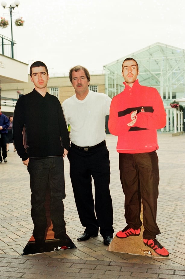 Tommy Gallagher, father of Oasis members, Liam and Noel Gallagher, pictures in Manchester with cardboard cut outs, advertising boards and a copy of the Oasis album 'Be Hear Now' Picture taken 21st August 1997. (Photo by Howard Walker/Mirrorpix/Getty Images)