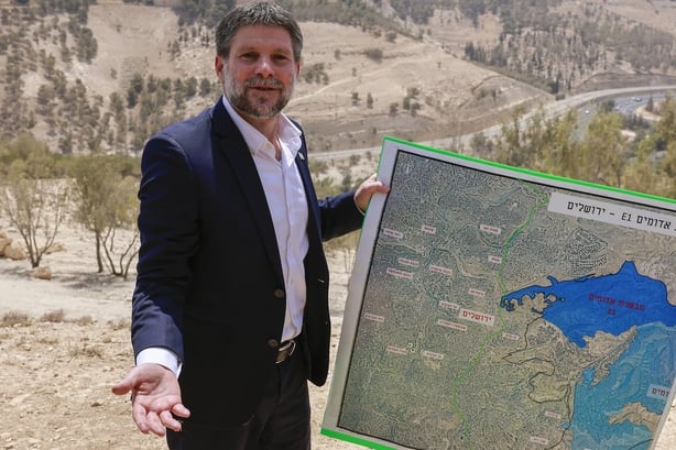 Israeli minister Bezalel Smotrich holds a map of an area near the settlement of Maale Adumim in the West Bank