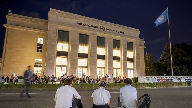Delegates and activists wait outside the assembly hall at the United Nations offices in Geneva
