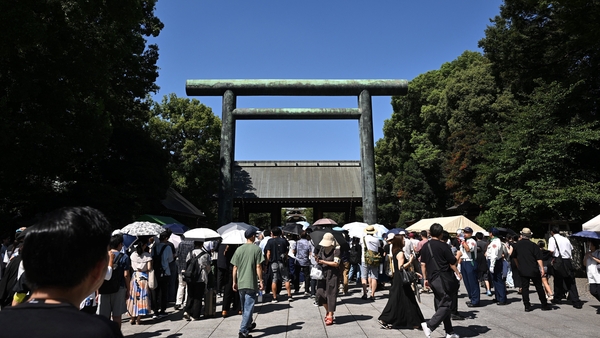 a shrine in Japan with a crowd in front