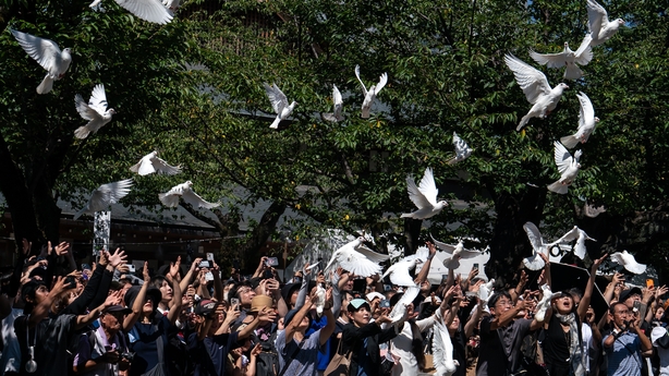 White doves are released as a tribute to the war dead at the Yasukuni Shrine in Tokyo, Japan