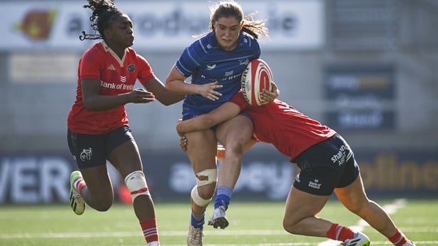 31 August 2024; Ella Roberts of Leinster is tackled by Enya Breen of Munster during the Vodafone Women's Interprovincial Championship final between Leinster and Munster at the Kingspan Stadium in Belfast. Photo by Shauna Clinton/Sportsfile