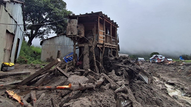 Damaged houses are pictured at the site of a flashflood at a village in Kishtwar