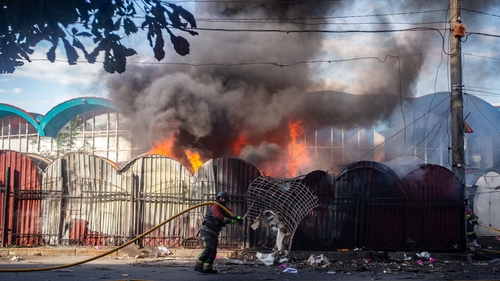 A firefighter at the central market in Sumy, Ukraine, after a fire caused by the explosion of a Russian drone started