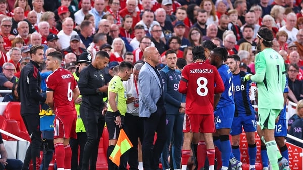 LIVERPOOL, ENGLAND - AUGUST 15: Referee Anthony Taylor speaks with both managers, Arne Slot manager / head coach of Liverpool and Andoni Iraola the head coach / manager of Bournemouth as Antoine Semenyo of Bournemouth reports racist abuse from a fan durin