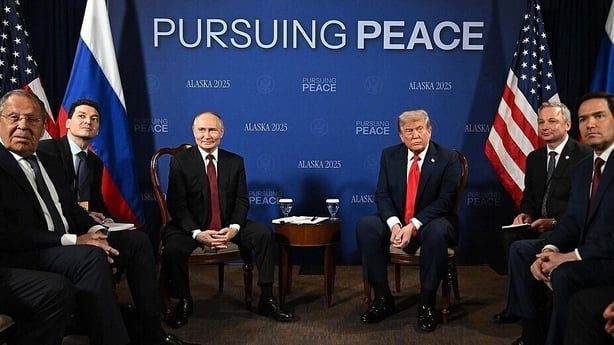 Vladimir Putin and Donald Trump sit with a group of men before talks in Alaska aimed at bringing an end to the war on Ukraine