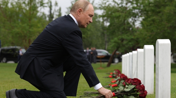 Vladimir Putin lays flowers at the graves of Soviet soldiers at Fort Richardson National Cemetery in Anchorage, Alaska