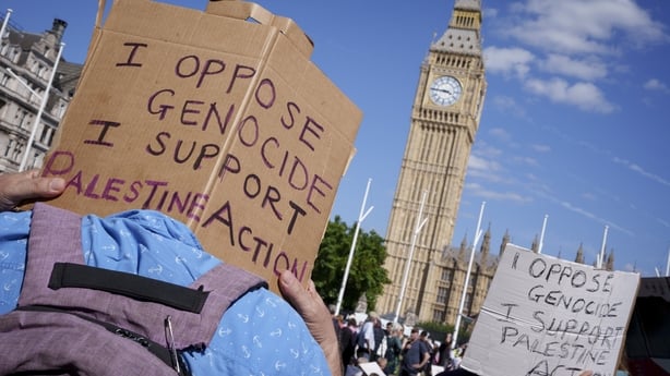 Activists hold signs in support of Palestine Action in Parliament Square in London