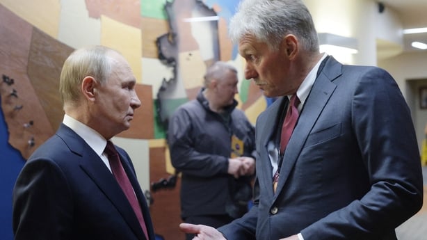 Russian President Vladimir Putin chats with Russian Presidential Press Secretary Dmitry Peskov