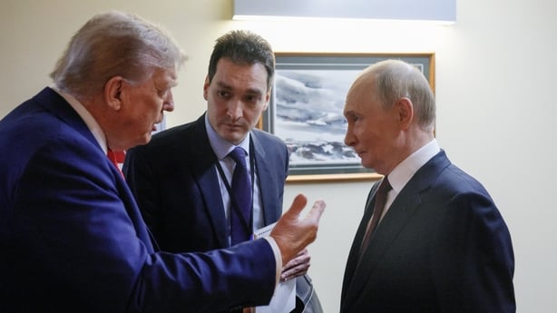 US President Donald Trump and Russian President Vladimir Putin chat before holding a joint press conference