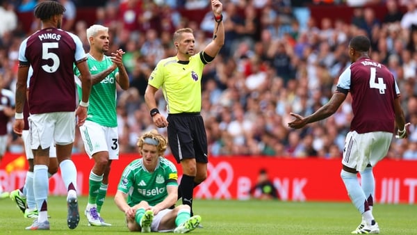 Ezri Konsa of Aston Villa is shown the red card by referee Craig Pawson during Premier League game v Newcastle, August 2025