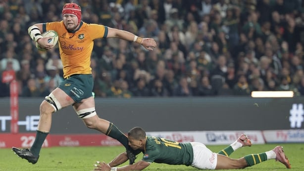 Australia's number eight Harry Wilson (L) runs with the ball to score