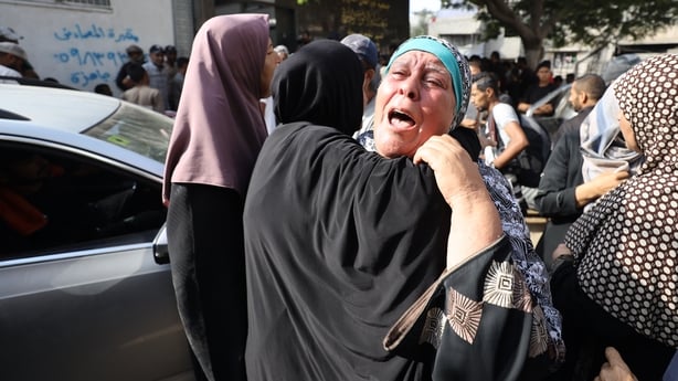 Relatives mourn as the bodies of six Palestinians from the same family who were killed in an Israeli attack are brought to Shifa Hospital in Gaza City.