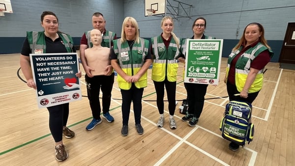 Members of the Castleblayney Community First Responders hold signs calling for a AED database