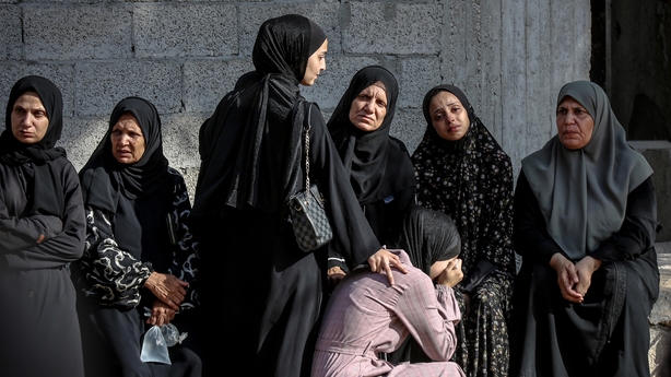 Relatives of the Palestinians who died as a result of the Israeli drone strike in the courtyard of Al-Ahli Baptist Hospital are seen mourning