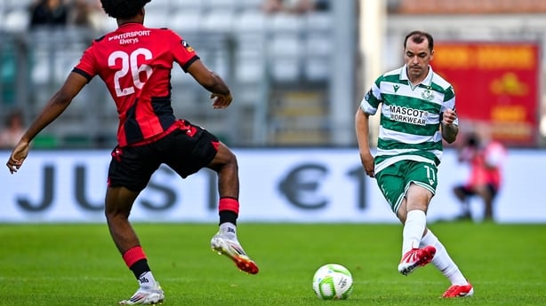 Seán Kavanagh of Shamrock Rovers in action against Stefan Ugbesia of Longford Town