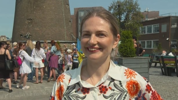 Oleksandra Havrylenko standing in front of a group of people.