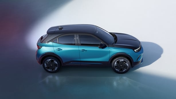 A side view of a teal green coloured car