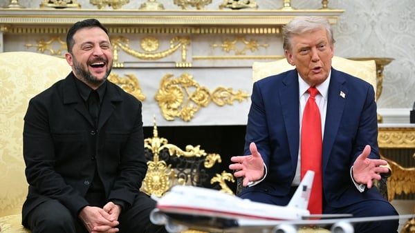 Volodymyr Zelensky laughs alongside and US President Donald Trump whoo gestures in the Oval Office
