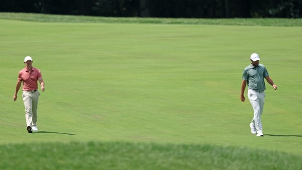OWINGS MILLS, MARYLAND - AUGUST 15: Rory McIlroy of Northern Ireland and Scottie Scheffler of the United States walk on the second hole during the second round of the BMW Championship 2025 at Caves Valley Golf Club on August 15, 2025 in Owings Mills, Mary
