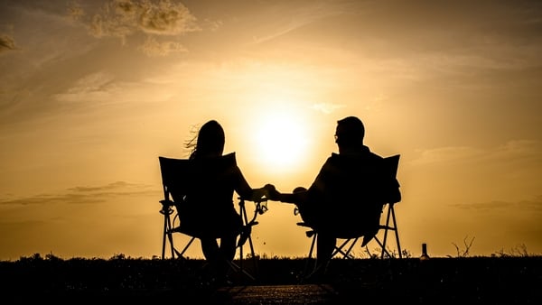 couple sitting outdoors at sunset