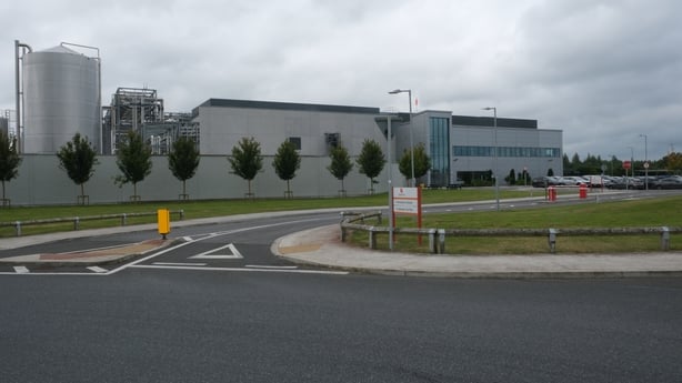 A road outside a grey factory