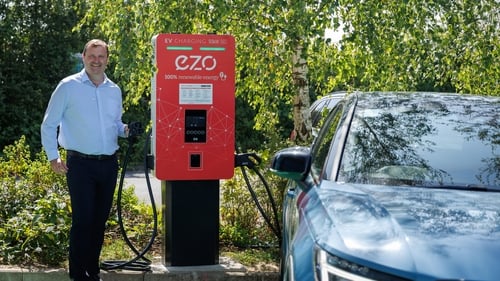 EZO's chief executive Ollie Chatten at one of the company's EV chargers