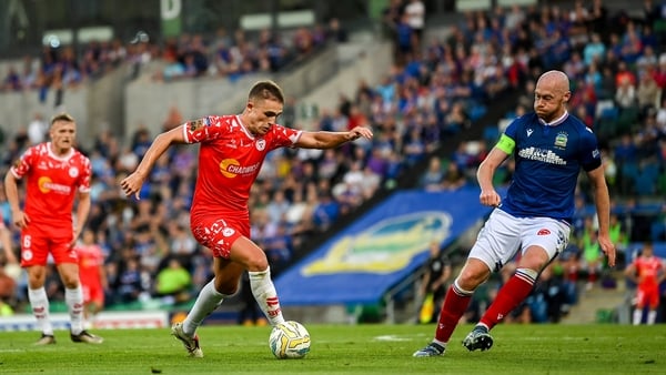 16 July 2025; Evan Caffrey of Shelbourne in action against Chris Shields of Linfield during the UEFA Champions League First Qualifying Round second leg match between Linfield and Shelbourne at Clearer Twist National Football Stadium at Windsor Park in Bel
