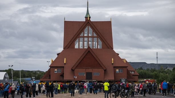 People gather to watch the relocation of the wooden Kiruna Church, in Kiruna, Sweden