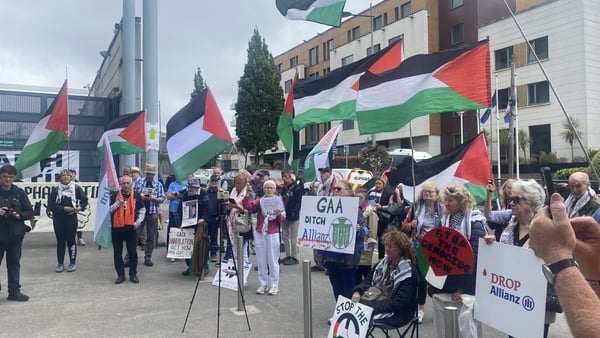 People wave Palestinian flags outside Croke Park during a protest against the GAA s connection to Allianz insurance