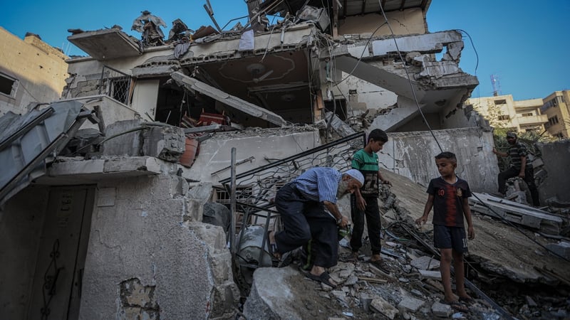Palestinians at the scene of an Israeli attack on a family home in Gaza city