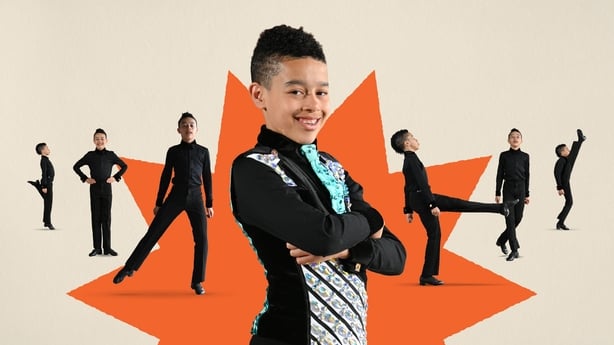 A young boy poses with images of him Irish dancing in the background.