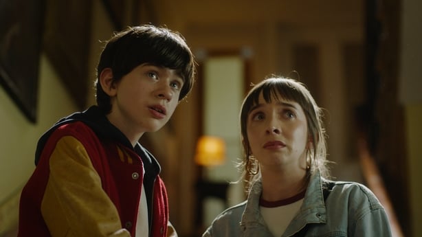 A boy and girl look scared.