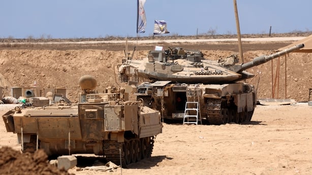 Israeli military vehicles are positioned along the border with the Gaza Strip 