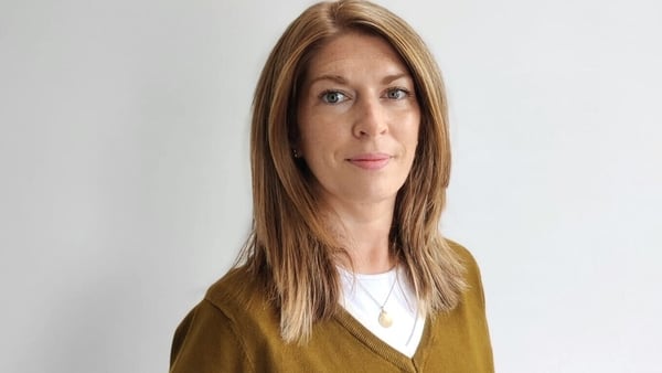 A woman poses for a photo.