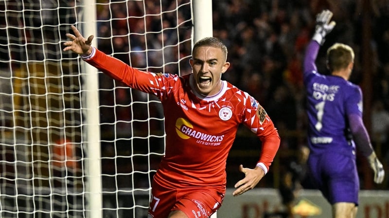 Evan Caffrey wheels away in celebration after scoring Shelbourne's third