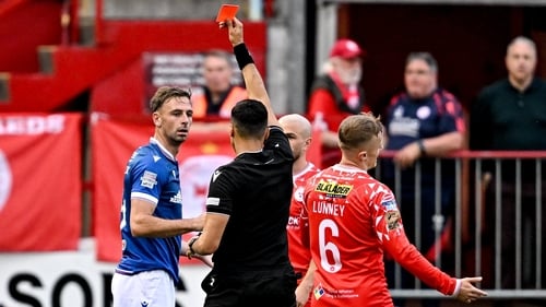 Referee Vassilis Fotias shows a red card to Matthew Fitzpatrick