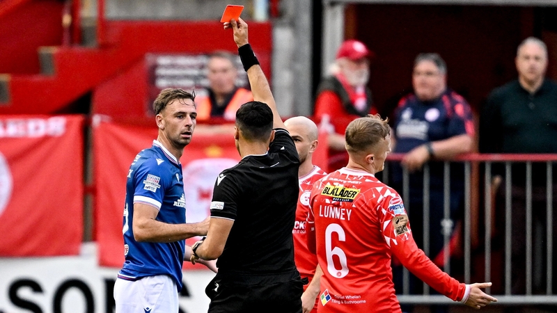 Referee Vassilis Fotias shows a red card to Matthew Fitzpatrick