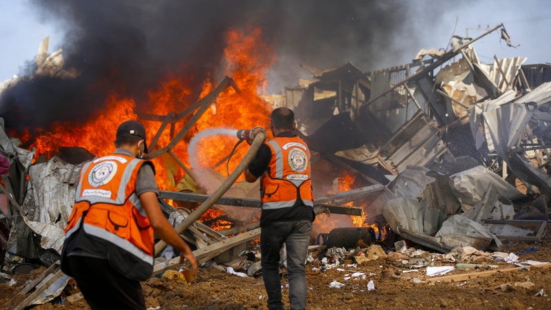 Palestinian Civil Defence teams battle a fire following an Israeli air strike in Deir al-Balah