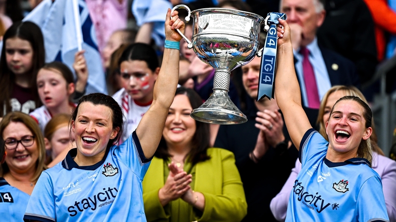 Leah Caffrey, left, and Martha Byrne lift the Brendan Martin Cup after Dublin defeated Meath on 3 August