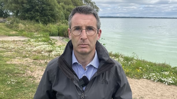 Andrew Muir standing in front of Lough Neagh