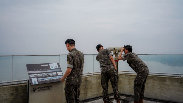 People look through binoculars