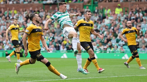 Celtic's Johnny Kenny (centre) scores his sides third goal against Livingston
