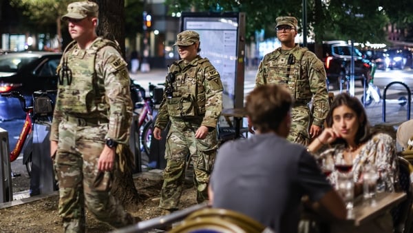 Members of the Ohio National Guard patrol near diners on 14th Street in Washington, DC, US