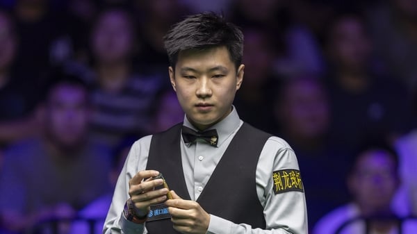 WUHAN, CHINA - AUGUST 24: Zhao Xintong of China chalks the cue against Iulian Boiko of Ukraine during the round one match on day one of the WST 2025 Wuhan Open at the Optics Valley Gymnasium of Huazhong University of Science and Technology on August 24, 2