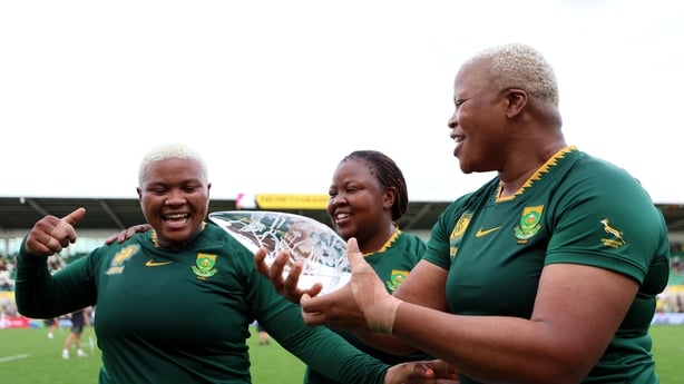 NORTHAMPTON, ENGLAND - AUGUST 24: Aphiwe Ngwevu celebrates with her MasterCard Player of the match award with teammates Sanelisiwe Charlie and Aseza Hele of South Africa after the Women's Rugby World Cup 2025 Pool D match between South Africa and Brazil at Franklin's Gardens on August 24, 2025 in No